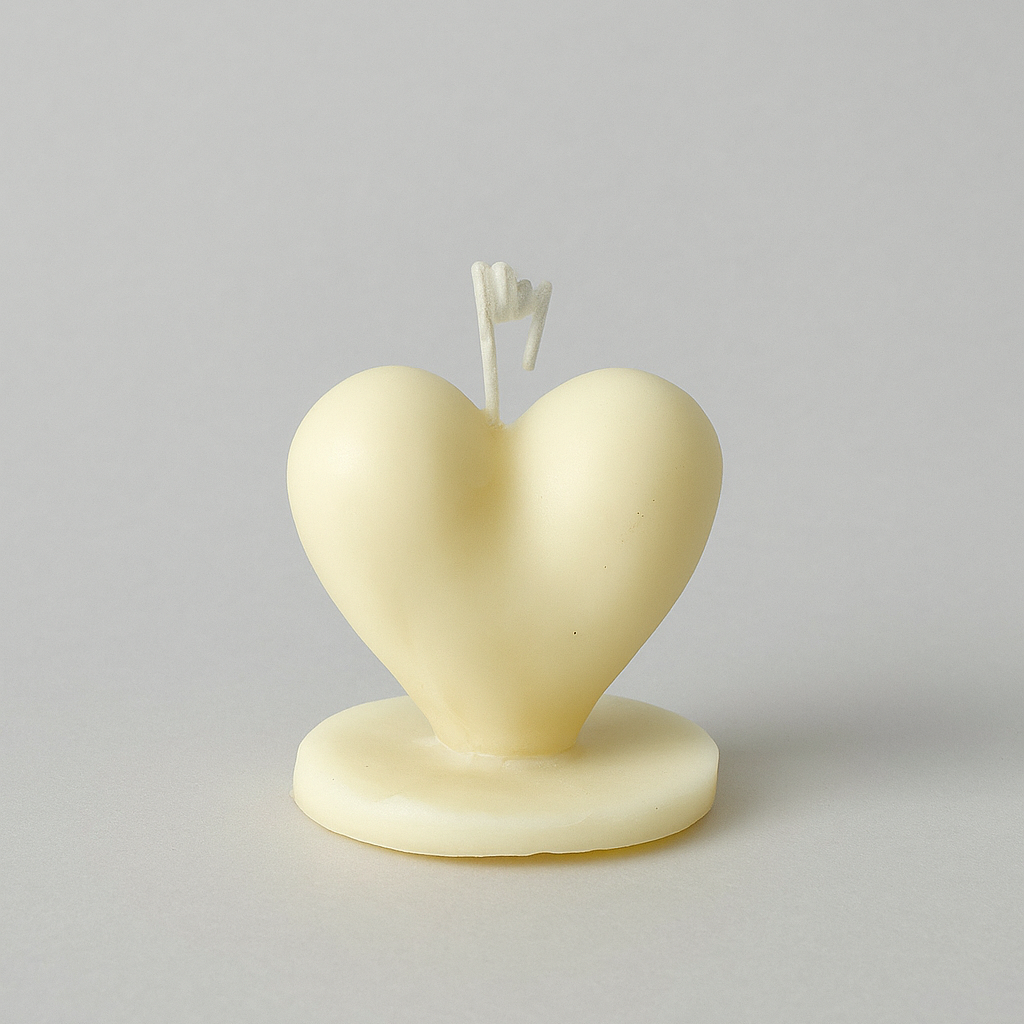 Heart-shaped candle on a gray background