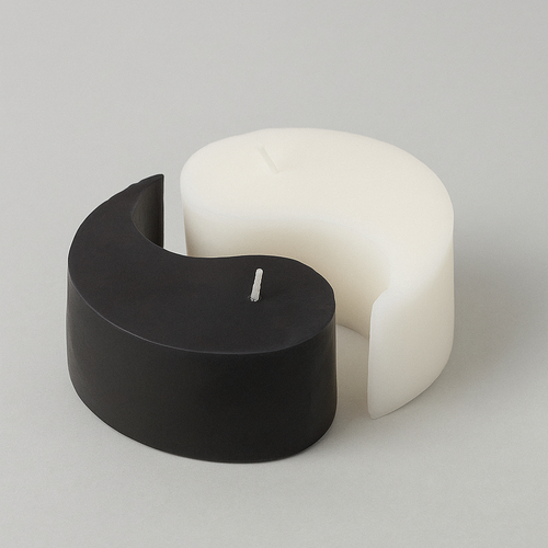 Black and white yin yang candle  on a light gray background